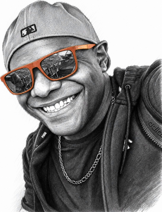 Sharrief Shabazz, leaning into frame with a smile, sunglasses, and a backwards cap.